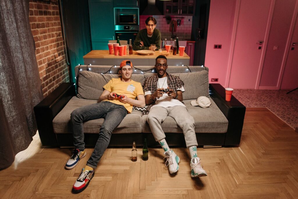 Three friends enjoying a gaming night in a cozy living room
