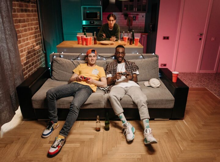 Three friends enjoying a gaming night in a cozy living room